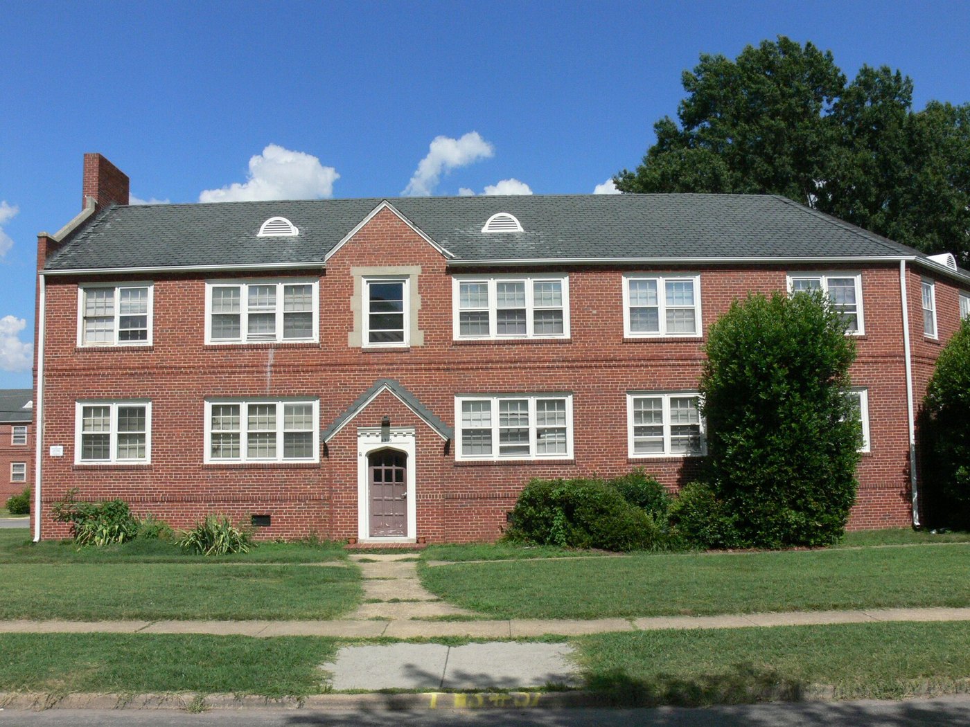 Modest brick multifamily with lawn — Southwest Ohio voucher-adjacent housing